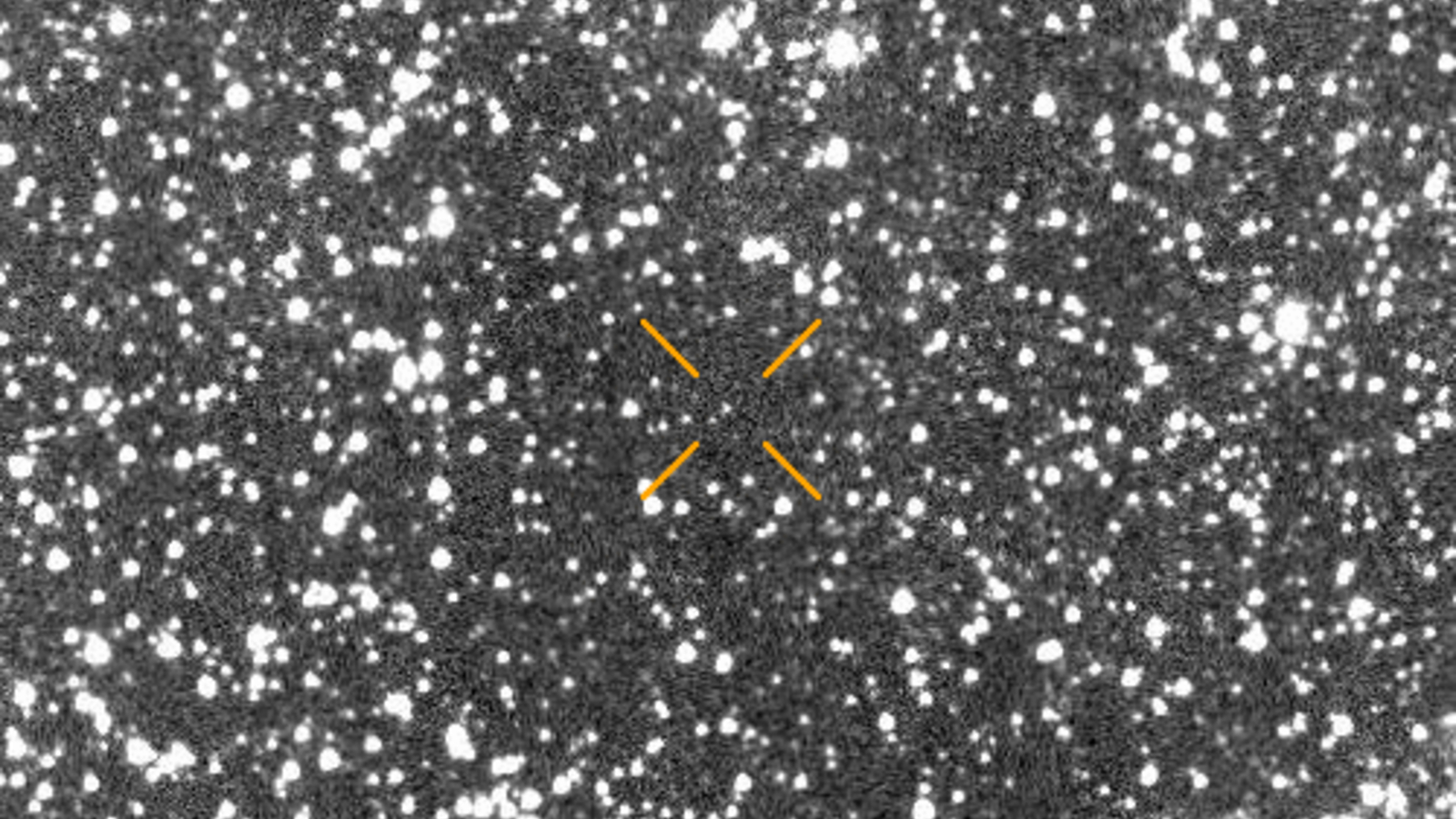 A blurry picture of stars with arrows pointing to where a comet is