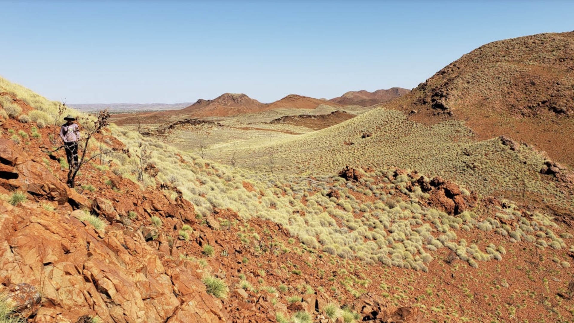 a photo of rolling hills with rocky outcrops