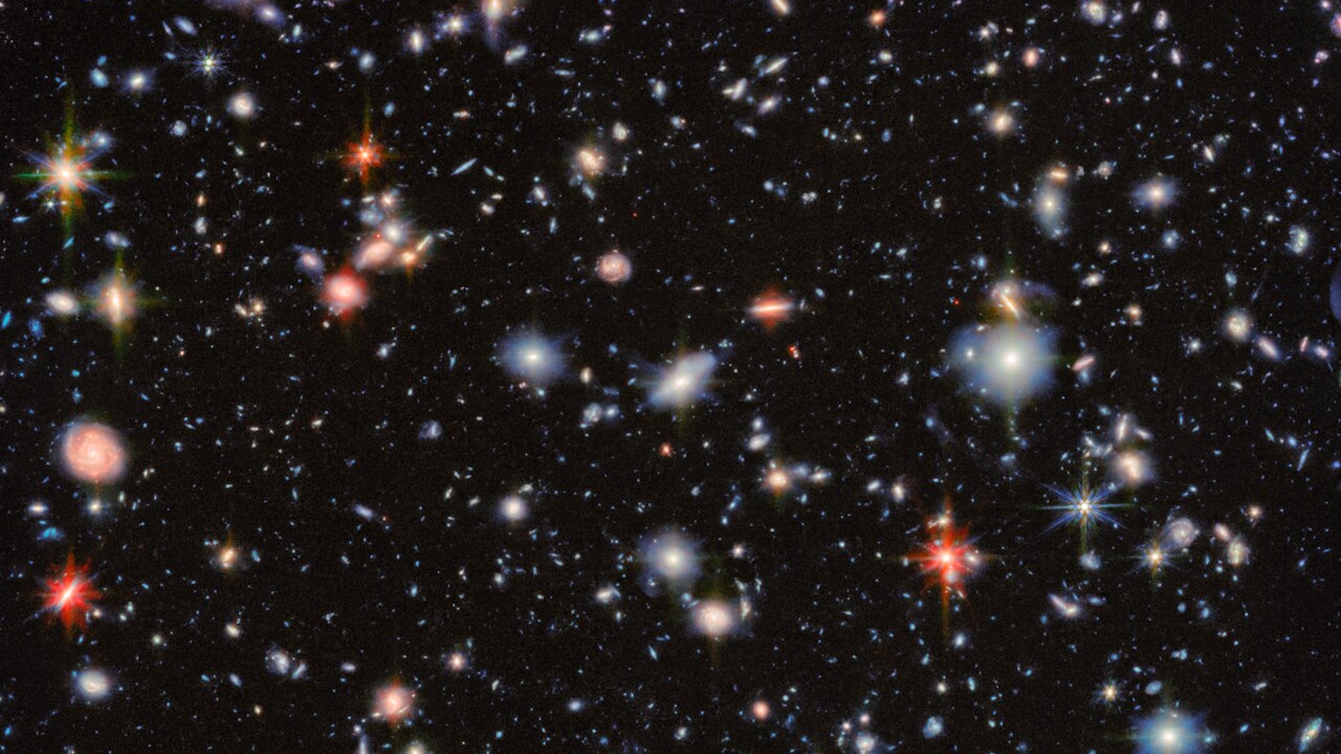 a deep field image showing many galaxies and stars