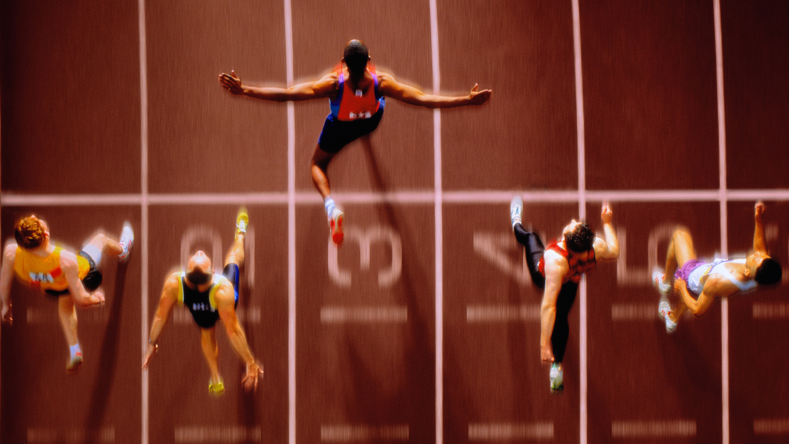 Athletes in race crossing finishing line, overhead view (Composite).
